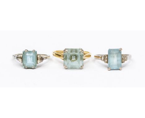 A collection of three aquamarine rings, to include a square cut claw set ring in 18ct yellow gold, size L, total gross weight