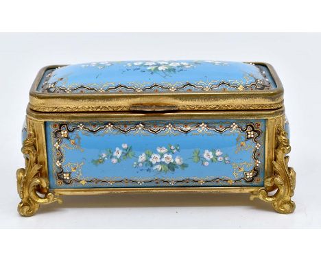 &nbsp;A French enamel and gilt metal box, late 19th Century, of rectangular form with leaf scroll feet, the enamel panels wit