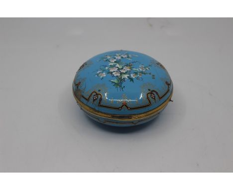 A French enamel box, of compressed globular form and decorated with flower sprays within black and gilt borders against a sky