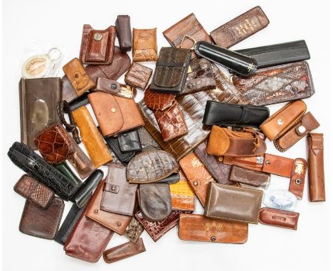A collection of various vintage leather and crocodile accessories, including manicure sets, pen holders, key holders and othe