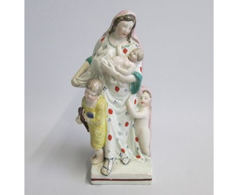 A Stafford Figure of Charity standing on a square baseDate: circa 1825Size: 7x7cm diameter, 19cm highCondition: right arm, cr