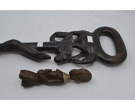 An ebonised carved wood walking stick carved with elephant handle together with a carved Masai warrior type figure (2)&nbsp;