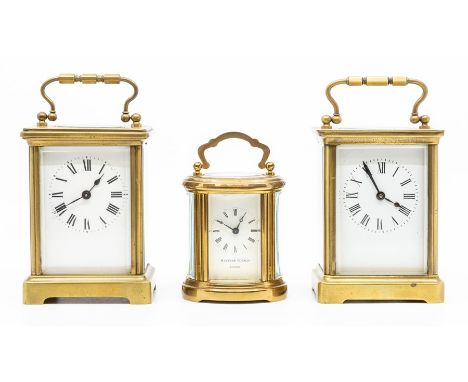 Two brass cased carriage clocks, first half 20th Century, of typical form with swing carry-handle, the unsigned white enamell
