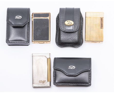 Three St.Dupont Paris cigarette lighters, circa third quarter 20th Century, the first yellow metal with engine-turned ribbed 