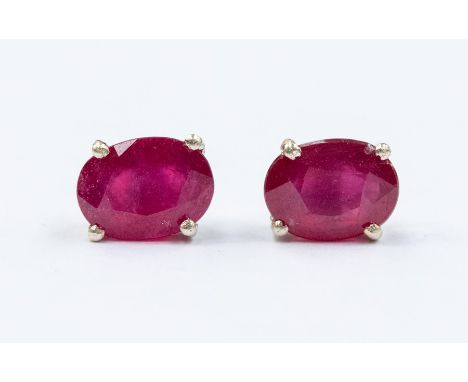 A pair of ruby and silver stud earrings, the oval rubies weighing a total of approx. 2.4carats, assessed as treated, four cla