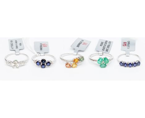 A collection of 10ct gold rings to include a rainbow sapphire and diamond cross over ring, a sapphire and diamond cluster rin