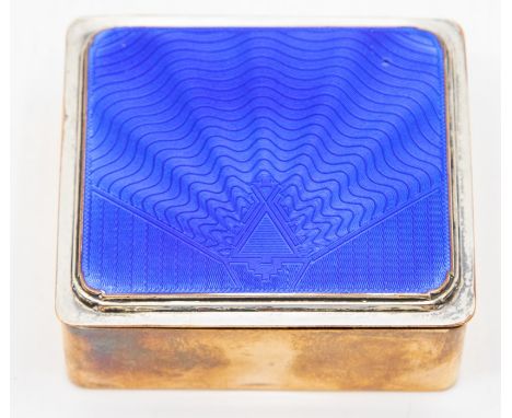 An early 20th Century enamelled Art Deco cigarette box, the cover with blue sun burst enamel decoration on a silver plated bo