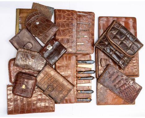 An assembled group of vintage crocodile gentleman's accessories, including two manicure sets, travel mirror, wallets, coin ho