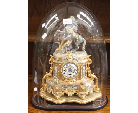 A late 19th Century gold gilt mantle clock with figure of man and horse by Coulson, French in design, on a gilt stand, with c