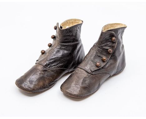 A pair of brown leather baby boy's boots with four button fastenings, 1860/70's, British design &nbsp;