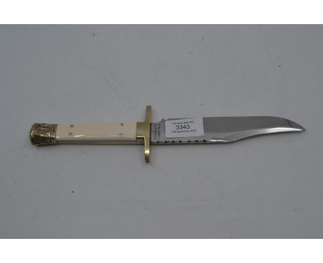 A vintage Bowie type fixed blade knife, full tang with bone grips, the pommel moulded with oak sprigs, brass cross guard, the