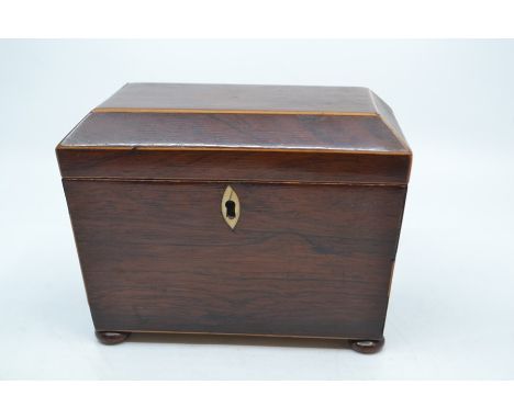 A 19th Century mahogany inlaid tea caddy, of sarcophagus form on four cushion feet, the interior with conforming divisional c