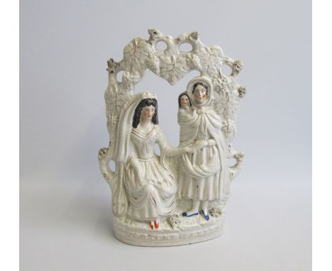 A Staffordshire Portrait figure of ‘Fortune Teller’ seated  within an arbour. Predominately decorated in White and Gilt  with