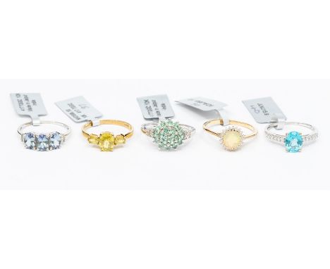 A collection of 10ct white and yellow gold rings, set with various stones to include a three stone sphene ring, apatite and w