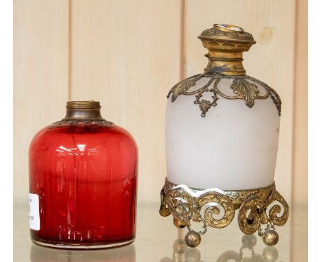 A French gilt metal mounted opalescent glass scent bottle, of cylindrical shape, the hinged top inset with an enamel of flowe
