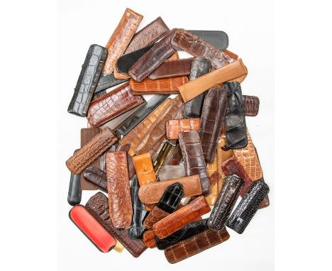 A collection of recent and vintage leather and crocodile comb holders, some complete with combs (a lot).Condition: combs appe