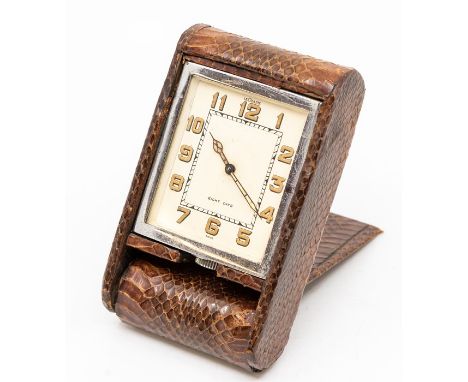A Jaeger-LeCoultre snakeskin cased travel clock, with eight day movement in dark brown folding case, 10cm (dial 5cm).C. R.: w