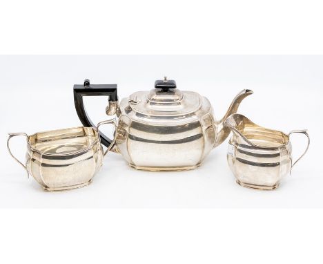 A George VI silver three piece tea service, the teapot with ebony pagoda finial and handle by George Mander &amp; Sons, Birmi