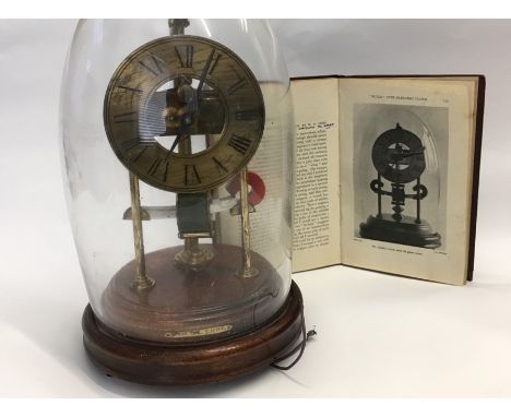 Bulle type electric mantel clock with brass dial, wooden base and glass dome. Together with Electric Clocks and How to Make T