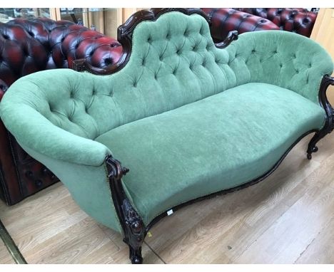 A Victorian walnut button backed settee, green upholstered, together with a pair of Victorian balloon back chairs; the settee