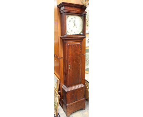 A George III oak eight day longcase clock, circa 1790, the hood with a projecting moulded cornice, the door set between split