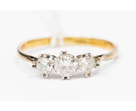A diamond and 18ct gold three stone ring, the double claw set round brilliant cut diamonds with a total diamond weight approx