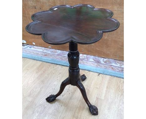 A Victorian mahogany tilt top tripod table, the petal shaped top with a dished edge, raised on a carved base, 70cm high, 52cm