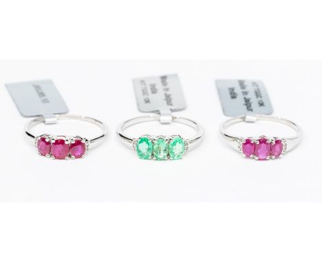 A collection of three 9ct white gold ring including two three stone ruby and diamond set rings, each with a total ruby weight