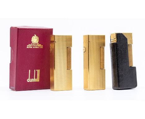 Three Dunhill cigarette lighters, 2nd half 20th Century, yellow metal and with engine-turned decoration, one with black leath