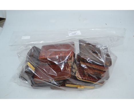 An assembled group of ten various vintage metal mounted crocodile cigarette cases. (10)Condition: generally good with some si