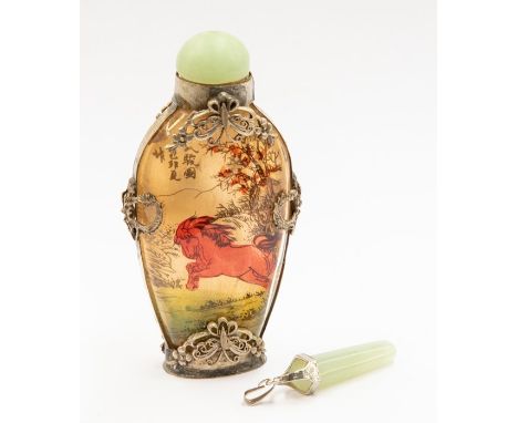 A Chinese scent bottle, jade lid and white metal applied decoration with a jade pendant, with white metal top and bale, total