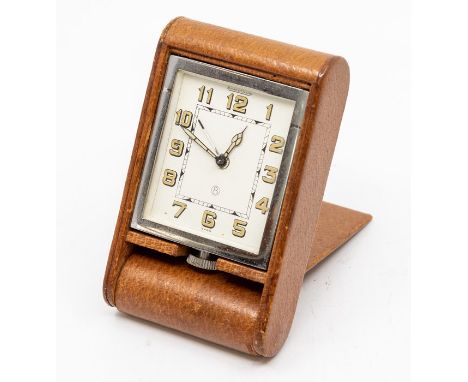 A Jaeger-LeCoultre leather-cased travel alarm clock, with eight day movement in tan folding case, 10cm (dial 5cm).C. R.: work