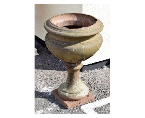 Antique terracotta coloured stoneware garden planter or urn of cauldron form with leaf decoration on spreading socle and squa