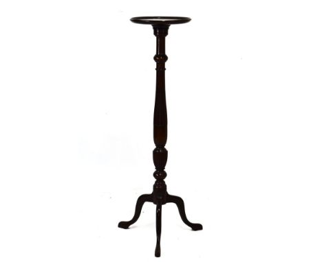 20th Century mahogany vase stand or torchère with dished circular top on fluted turned stem and tripod support   Condition: 