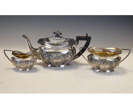 Edward VII silver three piece tea service, comprising: teapot, two handled sugar basin and milk jug, each with repousse folia
