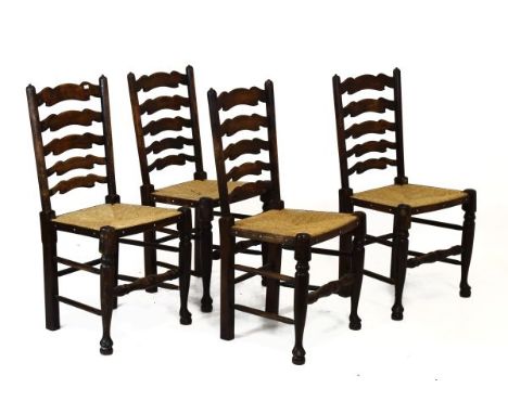 Set of four rush seated ladder back chairs, each with five rung shaped back between turned uprights, club legs to the front w
