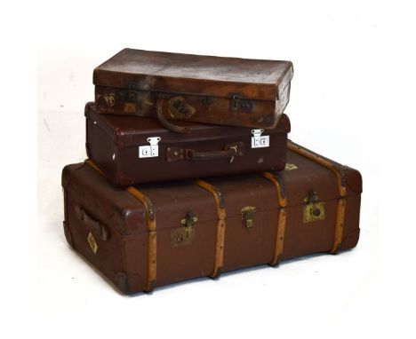 Three various trunks/suitcases comprising: a large cabin trunk with wooden ribs and canvas body, a hide travel suitcase and a