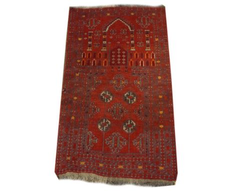 Middle Eastern wool prayer rug having typical geometric and architectural decoration on a red ground within multi borders, 11