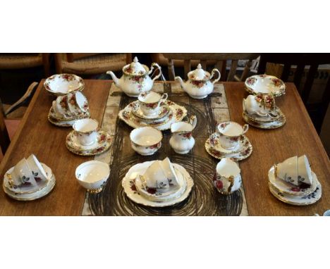Royal Albert Old Country Roses pattern tea service comprising: seven cups, eight saucers, six side plates, six bowls, teapot,