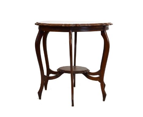 Edwardian walnut occasional table having a moulded wavy top and matching under shelf on six shaped supports and stretchers   