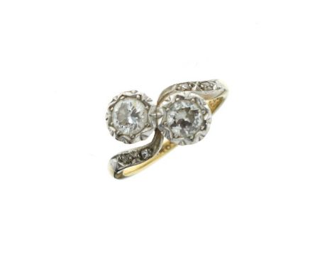 Two stone diamond crossover ring, diamond points to the shoulders, the yellow and white metal shank stamped 18ct Plat, size K