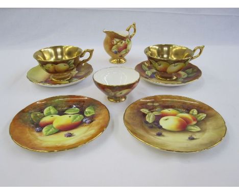 Pair of Coalport cabinet cups and saucers painted by M Pinter and R Dale, fruit with gilt interiors, a milk jug, saucers and 