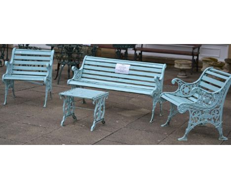 A Victorian Cast Iron and Wooden Slatted Three Piece Garden Set, comprising a garden bench with scrolled arms, the ends decor