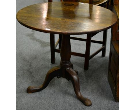 A George III Oak Tripod Table, late 18th century, the circular top raised on a baluster support with three cabriole legs, 83c