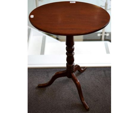 A George III Mahogany Fliptop Oval Tripod Table, early 19th century, labelled Druce & Co, Upholster and Cabinet Makers, Baker