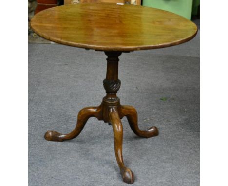 A George III Mahogany Fliptop Tripod Table, late 18th century, the circular top above a birdcage platform with baluster and p