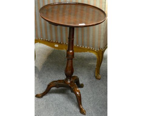 A George III Mahogany Tripod Table, late 18th century, the circular dished top above a turned baluster support with three car