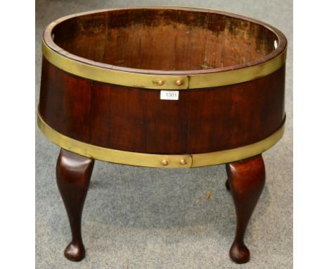 A George III Mahogany and Brass Bound Planter, circa 1800, of staved construction, raised on cabriole legs with pad feet, 56c