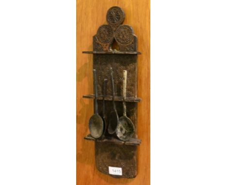 A 16th Century Oak Spoon Rack, of shaped form with decorative roundels, all-over carved decoration, bearing date 1572, 44cm h