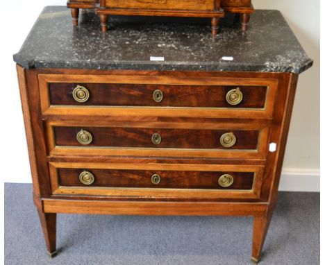 A 19th Century French Mahogany Transitional Style Marble Top Commode, the grey and white top of canted form above three drawe
